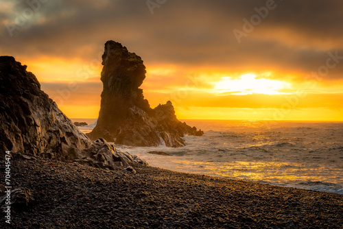 Sunset over the volcanic lava formations of Djupalonssandur beach, Iceland