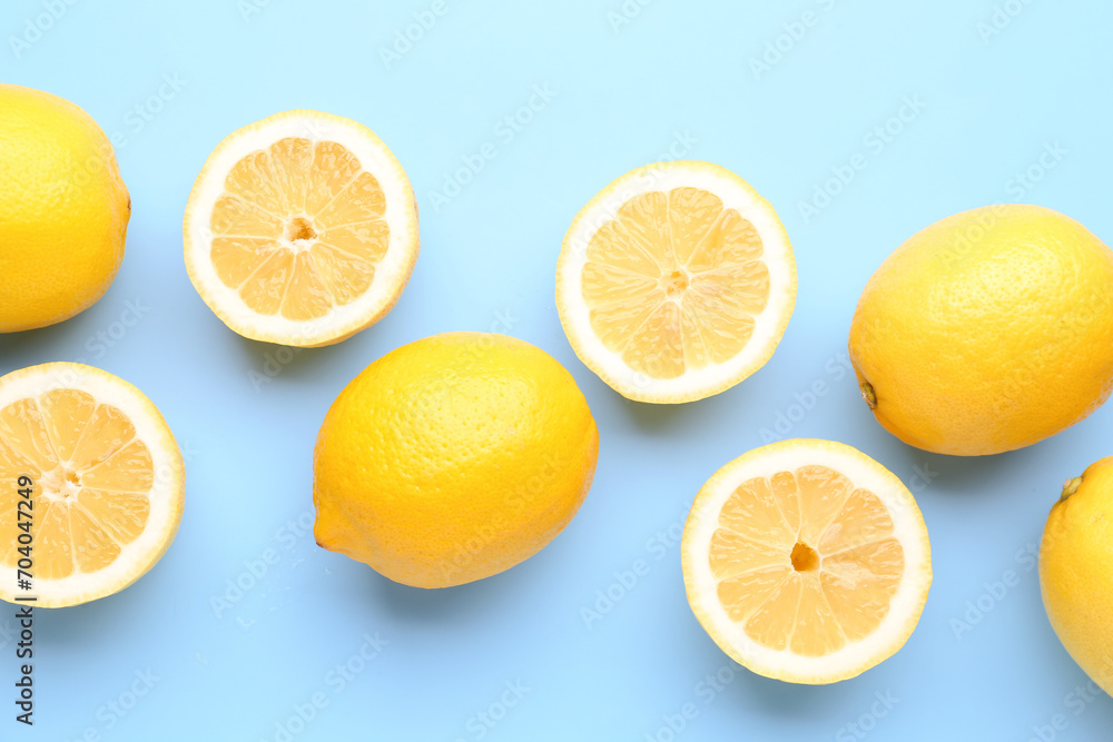 Composition with fresh lemons on blue background