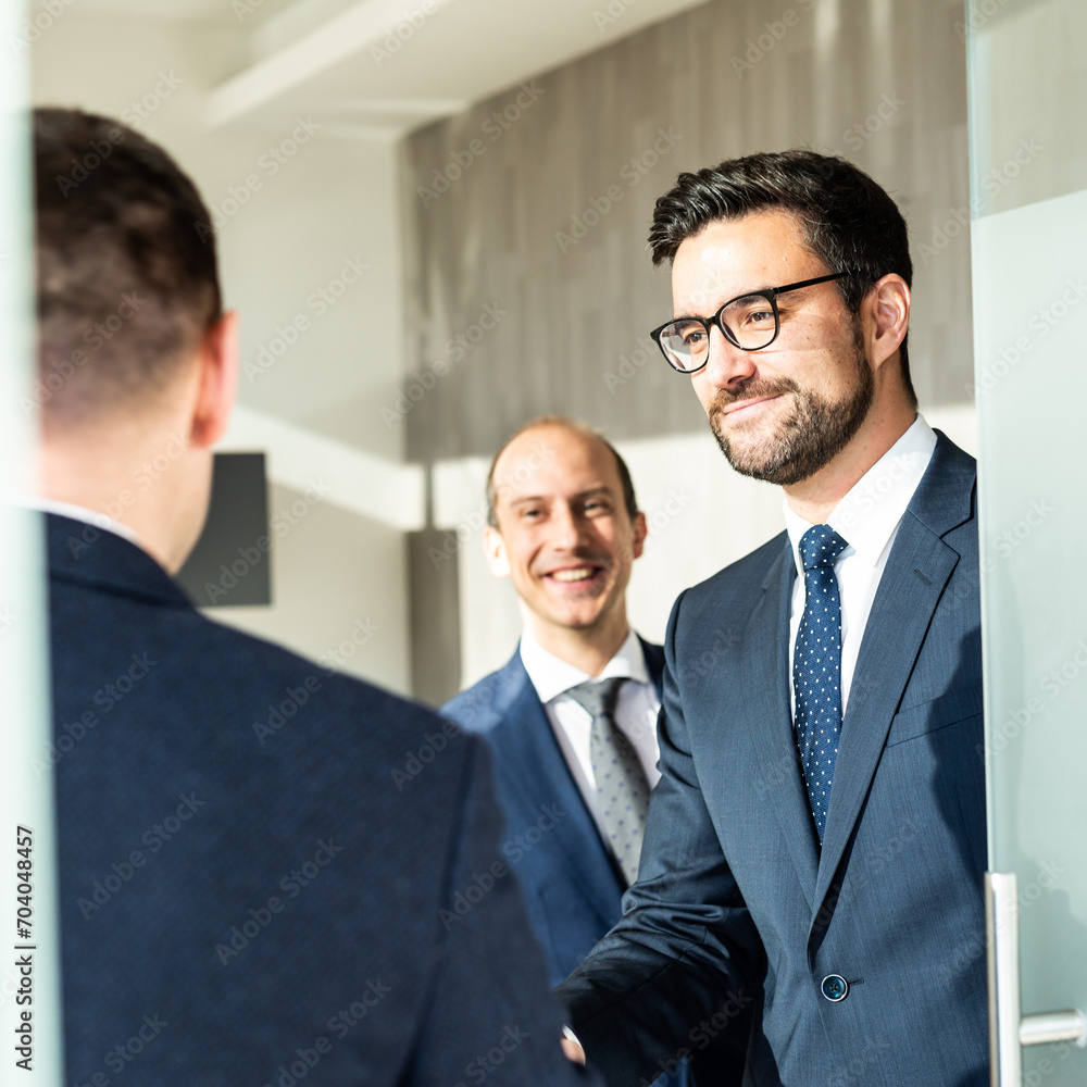 Group of confident business people greeting with a handshake at business meeting in modern office. Closing the deal agreement by shaking hands. Business and entrepreneurship success concept. Group of confident business people greeting with a handshake at business meeting in modern office. Closing the deal agreement by shaking hands. Business and entrepreneurship success concept.