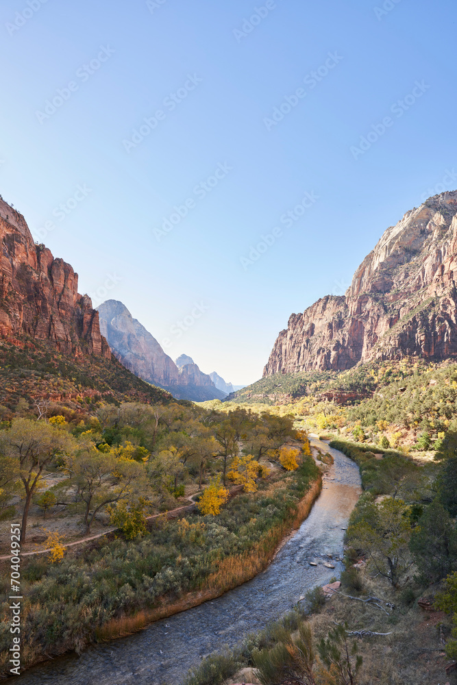 It is autumn, and the virgin river flows through the valley, located in zion national park