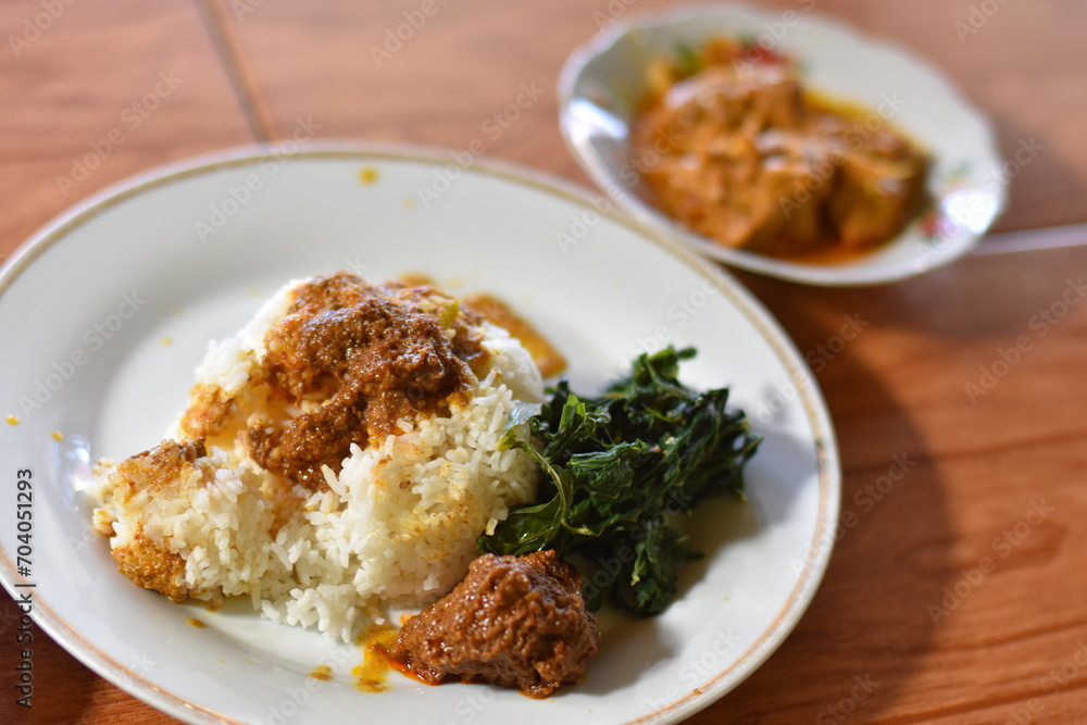 Nasi Padang with rendang is an Indonesian food from West Sumatra in Indonesia. Nasi Padang as favorites food for Indonesian people.
Nasi Padang with rendang is an Indonesian food from West Sumatra in Indonesia. Nasi Padang as favorites food for Indonesian people.