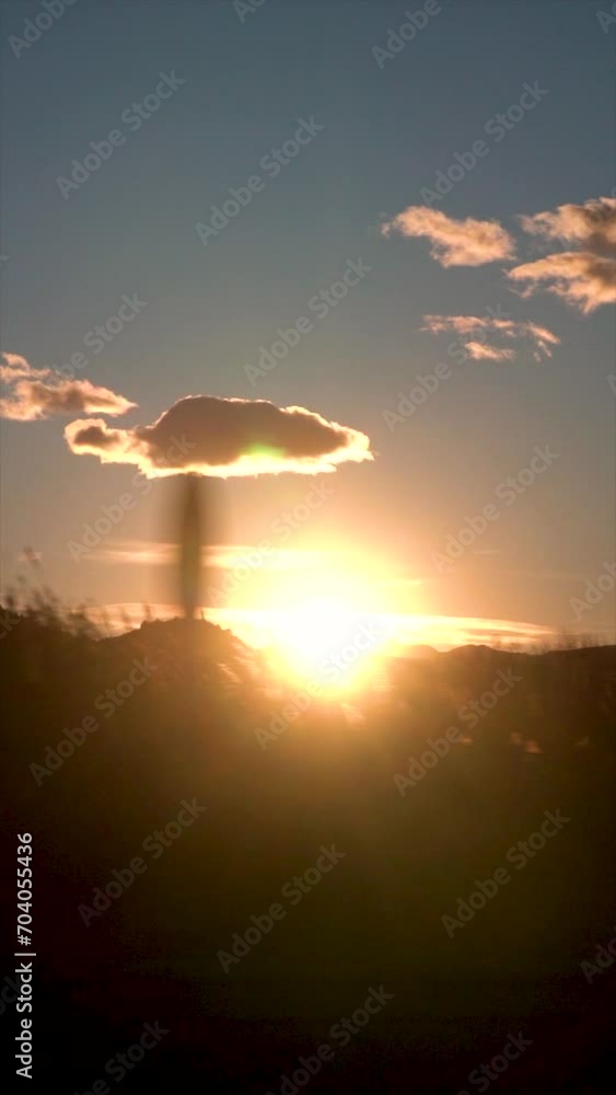 Slow motion. Traveling by car, views of an idyllic sunset, with the sun setting over the mountains. Slow motion. Traveling by car, views of an idyllic sunset, with the sun setting over the mountains.