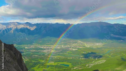 Beautiful Rainbow over Mount rundle mountain range in summer sunny day. banff national park, alberta, canada.  photo