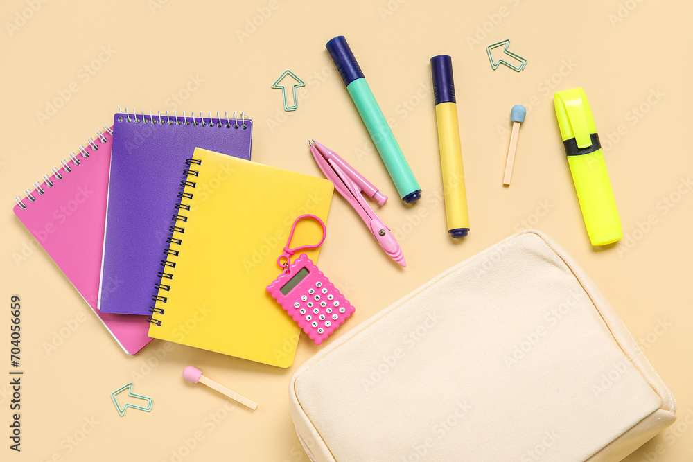 Pencil case with different school stationery on beige background Pencil case with different school stationery on beige background