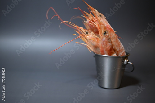 frozen pink queen shrimp in a bucket on a gray background
 photo