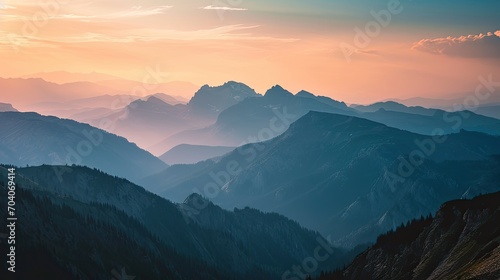 The sun is rising over a mountain range