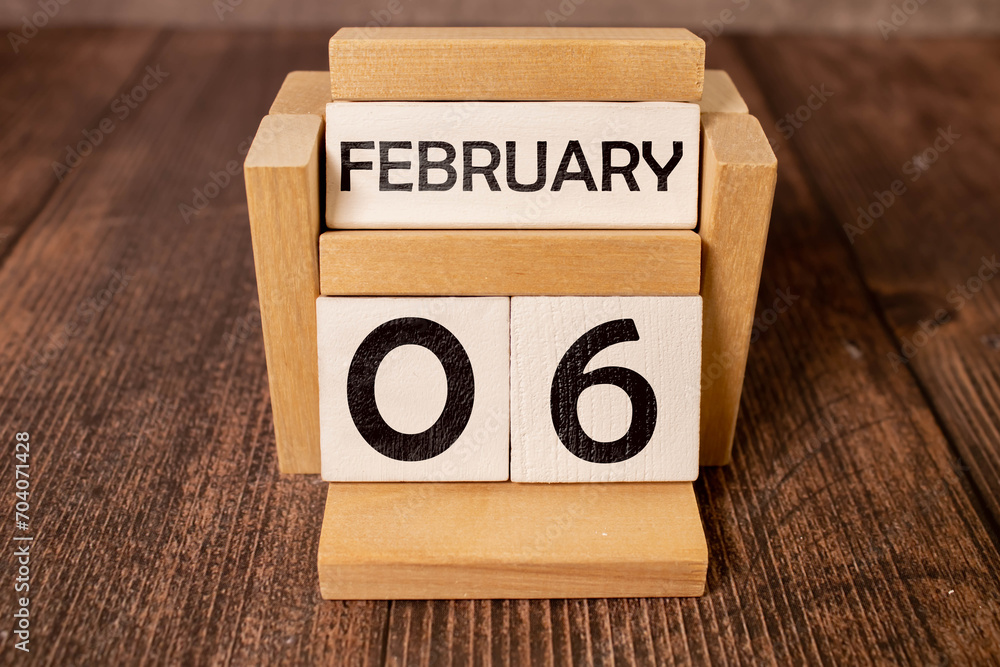 February 06 on wooden calendar, on dark gray background February 06 on wooden calendar, on dark gray background
