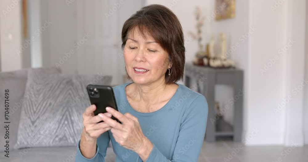 Attractive confident woman enjoying texting reading email holding mobile cell phone relaxing sitting in home. Attractive confident woman enjoying texting reading email holding mobile cell phone relaxing sitting in home.