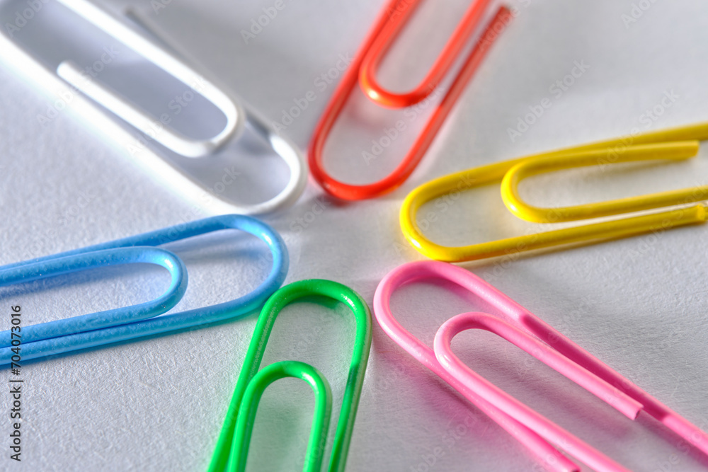 Multi colored paper clips are folded in shape star white background. Multi colored paper clips are folded in shape star white background.
