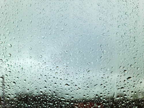 Rain drops running down a window in a close up view.
