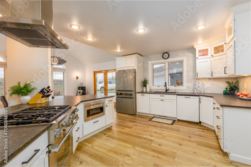 Kitchen with center island  stainless steel appliances and wooden flooring