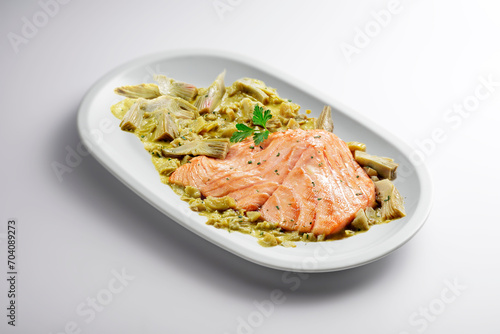 Oval plate with salmon fillet and artichoke garnish