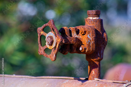 old and rusty faucet of obsolete chemical industrial equipment
