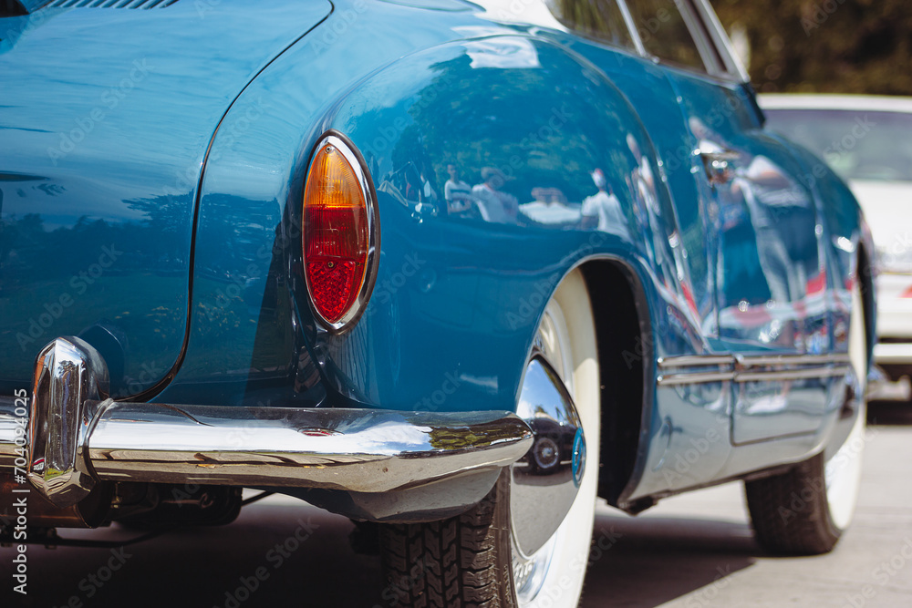 Fototapeta premium Classic retro car with close-up on headlights. Summer hot car parked on a beach. 