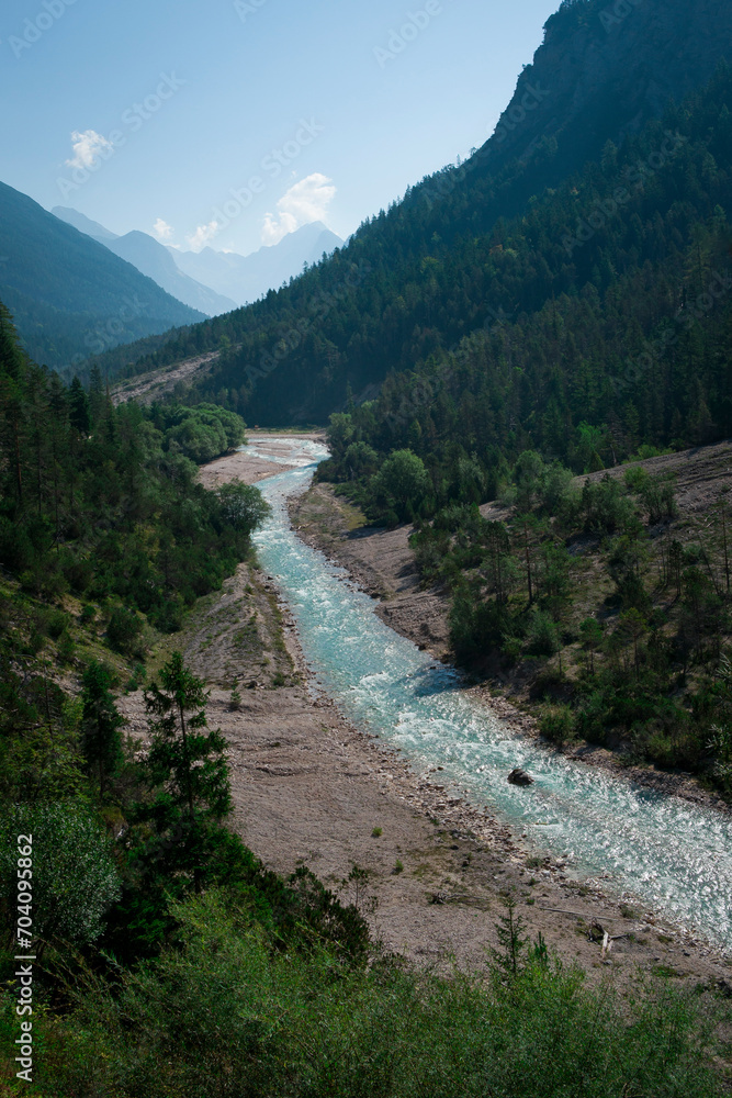 Turquoise river Isar flowing through the Karwendel mountains during sunny blue sky day in summer, Tyrol Austria. Turquoise river Isar flowing through the Karwendel mountains during sunny blue sky day in summer, Tyrol Austria.