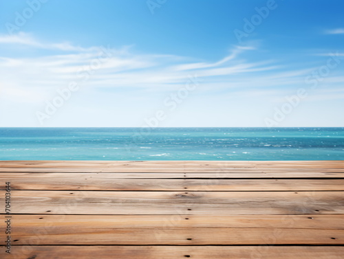 Wooden dock over blurred ocean and bright blue sky background