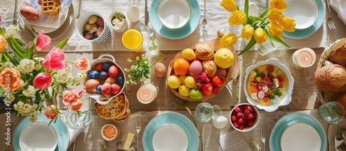 Top view of Easter meal table setting for breakfast or brunch with loved ones.