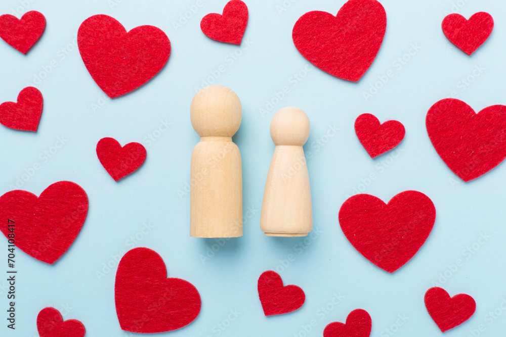 Wooden couple in love on color background, top view. Creative valentine's day composition