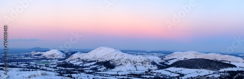 View across very wintery Shropshire hills with pleasing colour in sky at sunset. photo