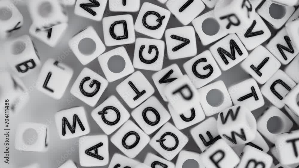 Close-up lot of white plastic decorative cubes with alphabet letters falling down moving randomly and mixing Close-up lot of white plastic decorative cubes with alphabet letters falling down moving randomly and mixing