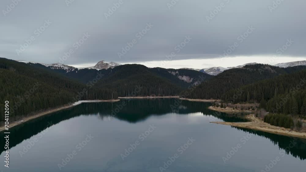 Flying over a mountain lake in the early winter season. Aerial view of Bolboci lake, Bucegi national park,
Carpathian Mountains, Romania.
Flying over a mountain lake in the early winter season. Aerial view of Bolboci lake, Bucegi national park,
Carpathian Mountains, Romania.