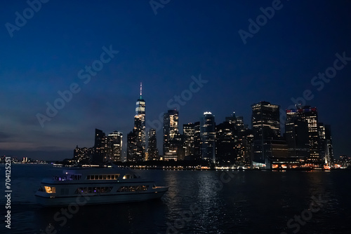 Boat parties in the Hudson River next to the New York skyline at night