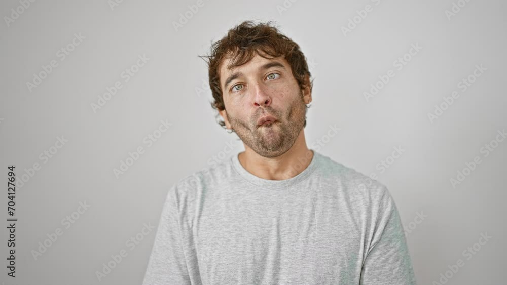 Cheerful young man in a t-shirt, making a funny fish face gesture with lips - crazy fun and comical expression, isolated on a white background Cheerful young man in a t-shirt, making a funny fish face gesture with lips - crazy fun and comical expression, isolated on a white background