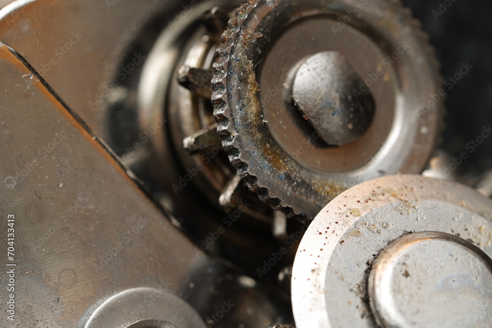 Close-up of mechanical gears showing intricate details and signs of wear Close-up of mechanical gears showing intricate details and signs of wear
