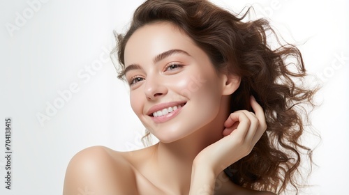 Portrait of a beautiful young woman with brown hair and light makeup smiling