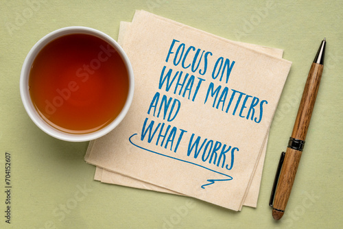 focus on what matters and what works - inspiraitonal writing on a napkin, productivity and priority concept photo