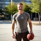 Smiling man holding a basketball