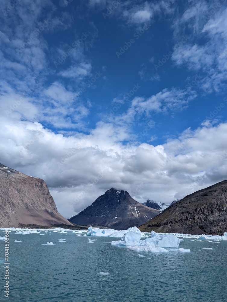 Mountains and fjord with icebergs in Greenland