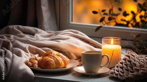 cozy still life with croissant and coffee by the window