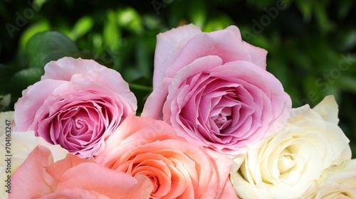 Beautiful bouquet of roses on light grey table outdoors, closeup