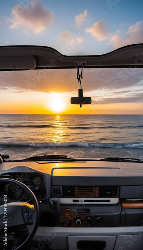 Sunset in front of the sea from inside a van