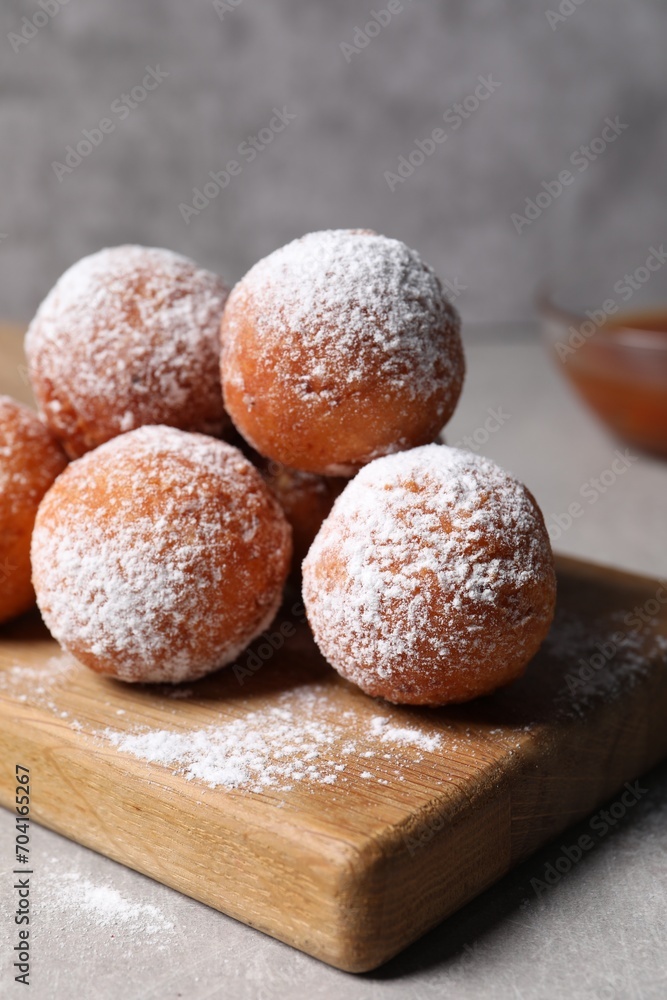 Delicious sweet buns with powdered sugar on table, closeup