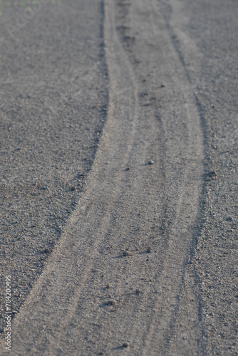sandy ground with tire tracks