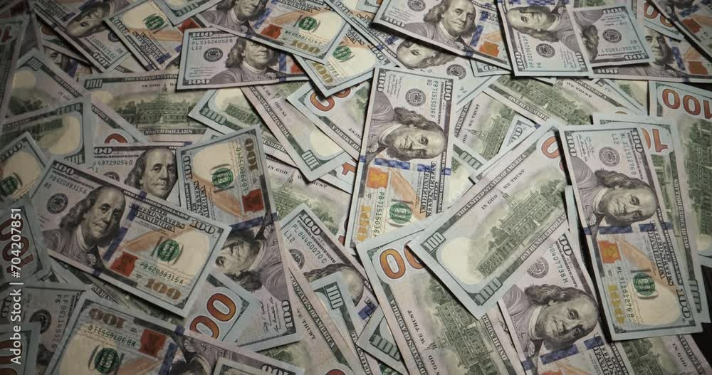 Hundred dollar bills are randomly laid out on surface. Wind sweeps American hundred dollar bills from surface. Cash represents economic independence and investment element of financial concepts. Hundred dollar bills are randomly laid out on surface. Wind sweeps American hundred dollar bills from surface. Cash represents economic independence and investment element of financial concepts.