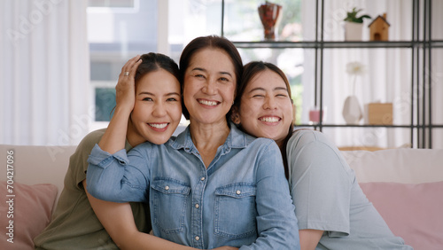 Fotografija Happy good warm time Mother day two grown up kid child looking at camera cuddle hug arm around mature mum