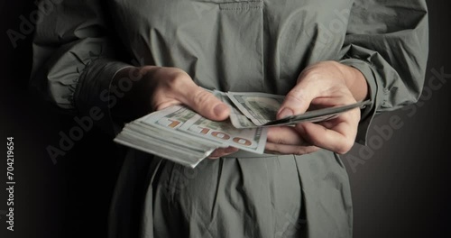 In background, men's hands count stacks of hundred dollar bills. Effective budgeting and financial planning. Successful money management. Close-up of counting money. American currency management.