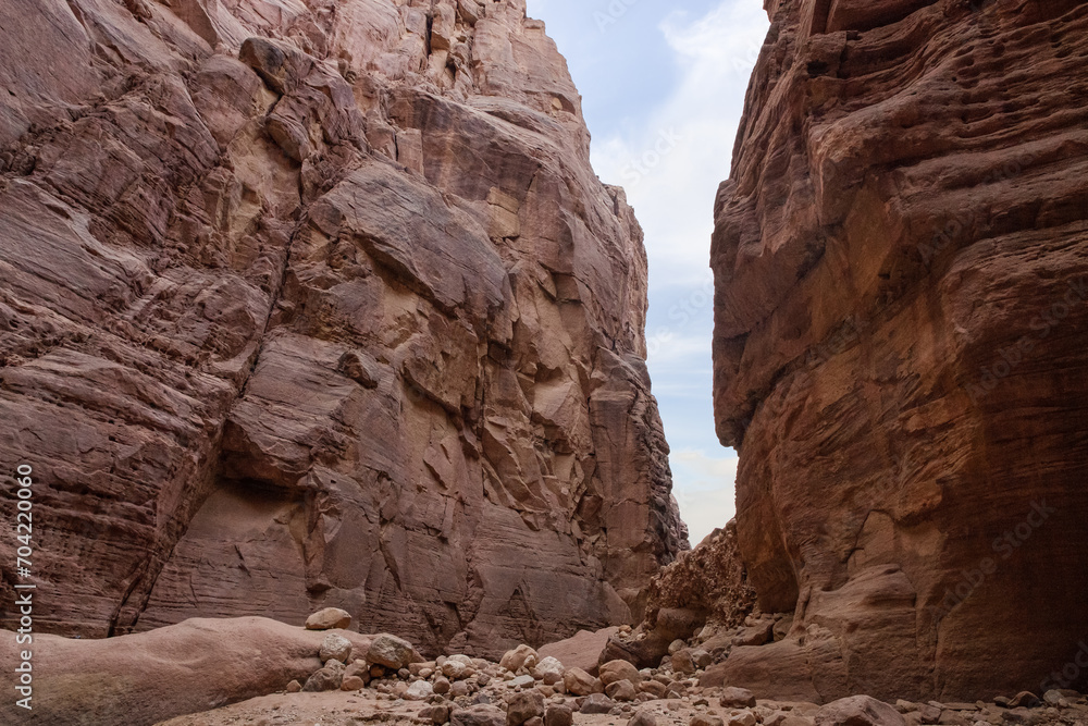 High  rocks with beautiful natural patterns at end of the hiking trail in Wadi Numeira gorge in Jordan