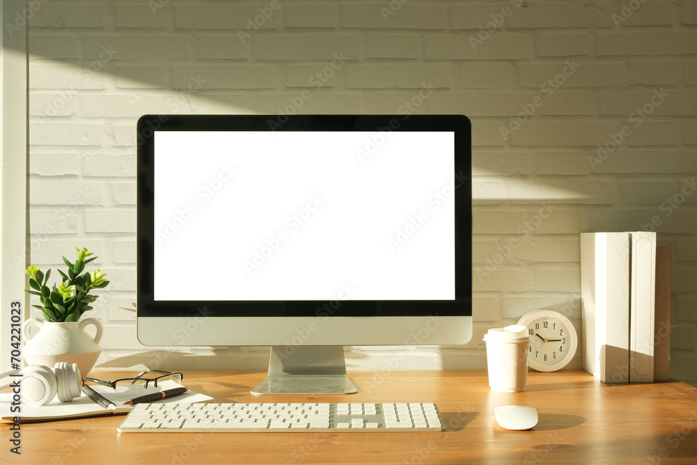 Minimal workspace with white screen computer and office supplies on wood table. Minimal workspace with white screen computer and office supplies on wood table.