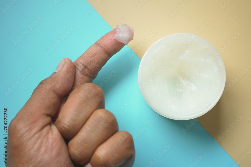 Close up of man hand using petroleum jelly Close up of man hand using petroleum jelly