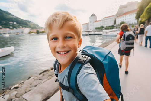 Happy traveller child with backpack taking selfie picture - Travel blogger Life style and technology concept © sam