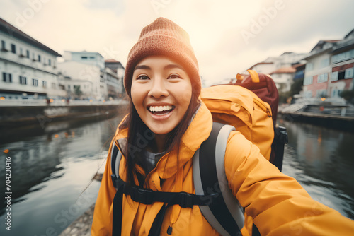 Happy traveller Asian teen with backpack taking selfie picture - Travel blogger Life style and technology concept photo