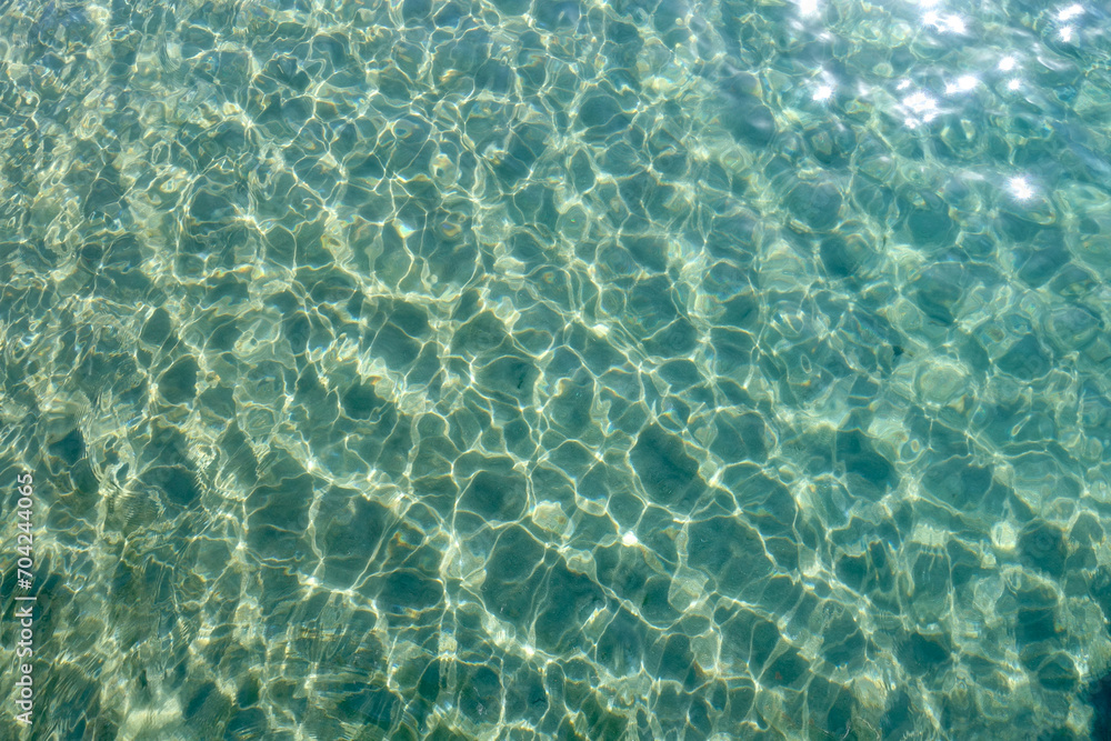 Obraz premium Clean transparent sea water, lake bottom and sand. Beautiful blue, turquoise transparent surface