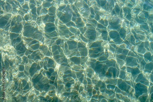 Clean transparent sea water, lake bottom and sand. Beautiful blue, turquoise transparent surface