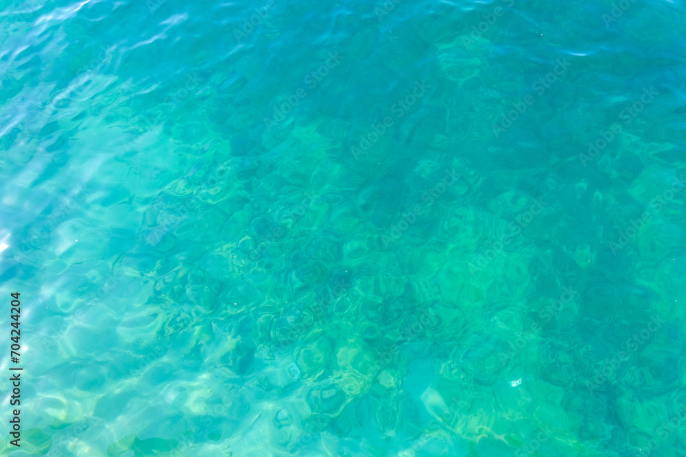 Clean transparent sea water, lake bottom and sand. Beautiful blue, turquoise transparent surface