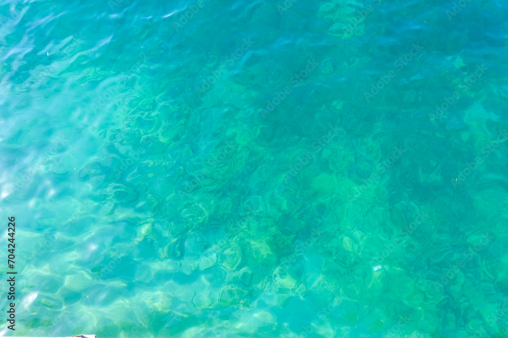 Clean transparent sea water, lake bottom and sand. Beautiful blue, turquoise transparent surface Clean transparent sea water, lake bottom and sand. Beautiful blue, turquoise transparent surface