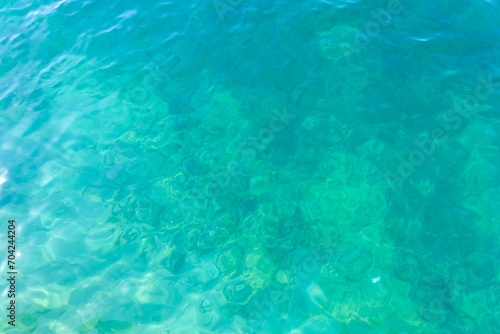 Clean transparent sea water, lake bottom and sand. Beautiful blue, turquoise transparent surface